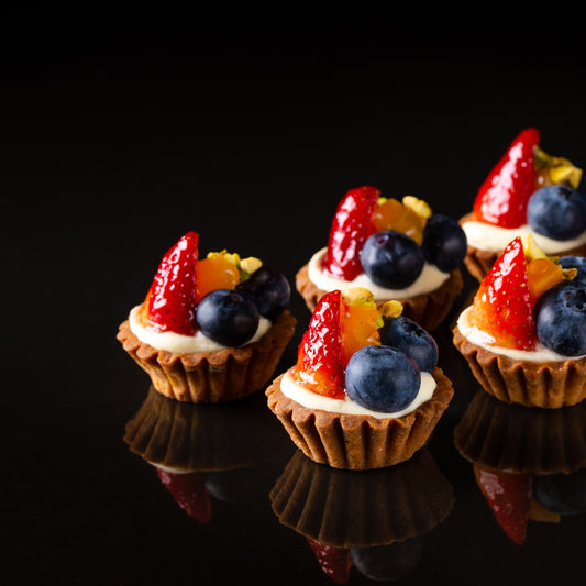 The French fruit tart, also known as "tarte aux fruits" in French, is a classic pastry consisting of a crisp pastry crust filled with a creamy or custard-like filling and topped with an assortment of fresh fruits.